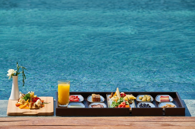 Tray of Food Beside Body of Water