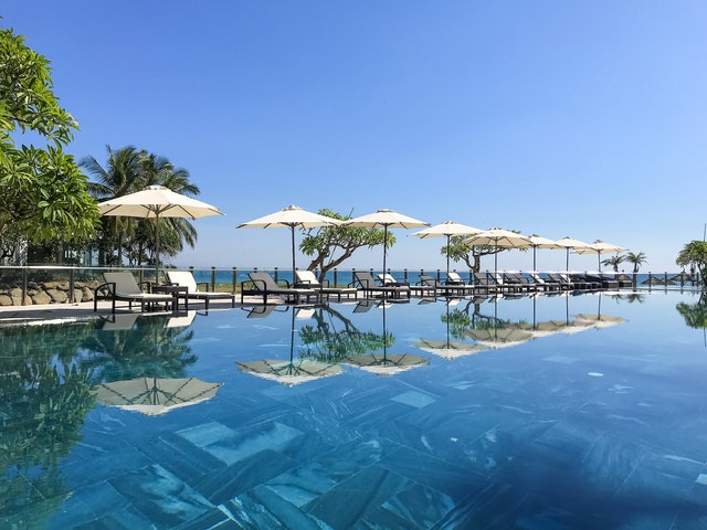White Patio Umbrellas Near Swimming Pool