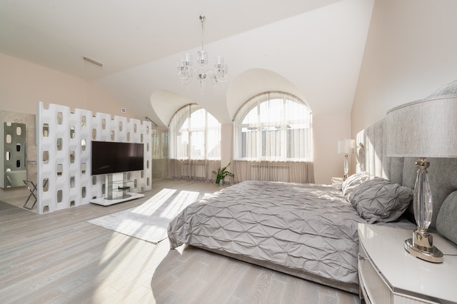Bedroom interior with bed near window and TV